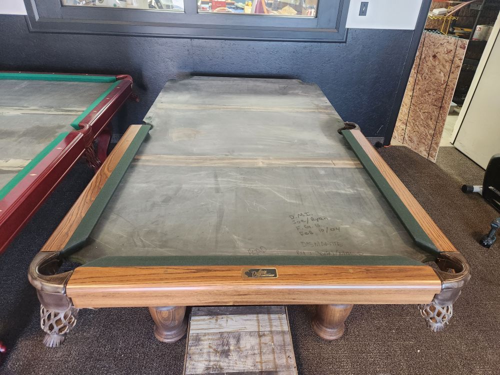 Close-up of the Dufferin pool table's oak rail and slate bed